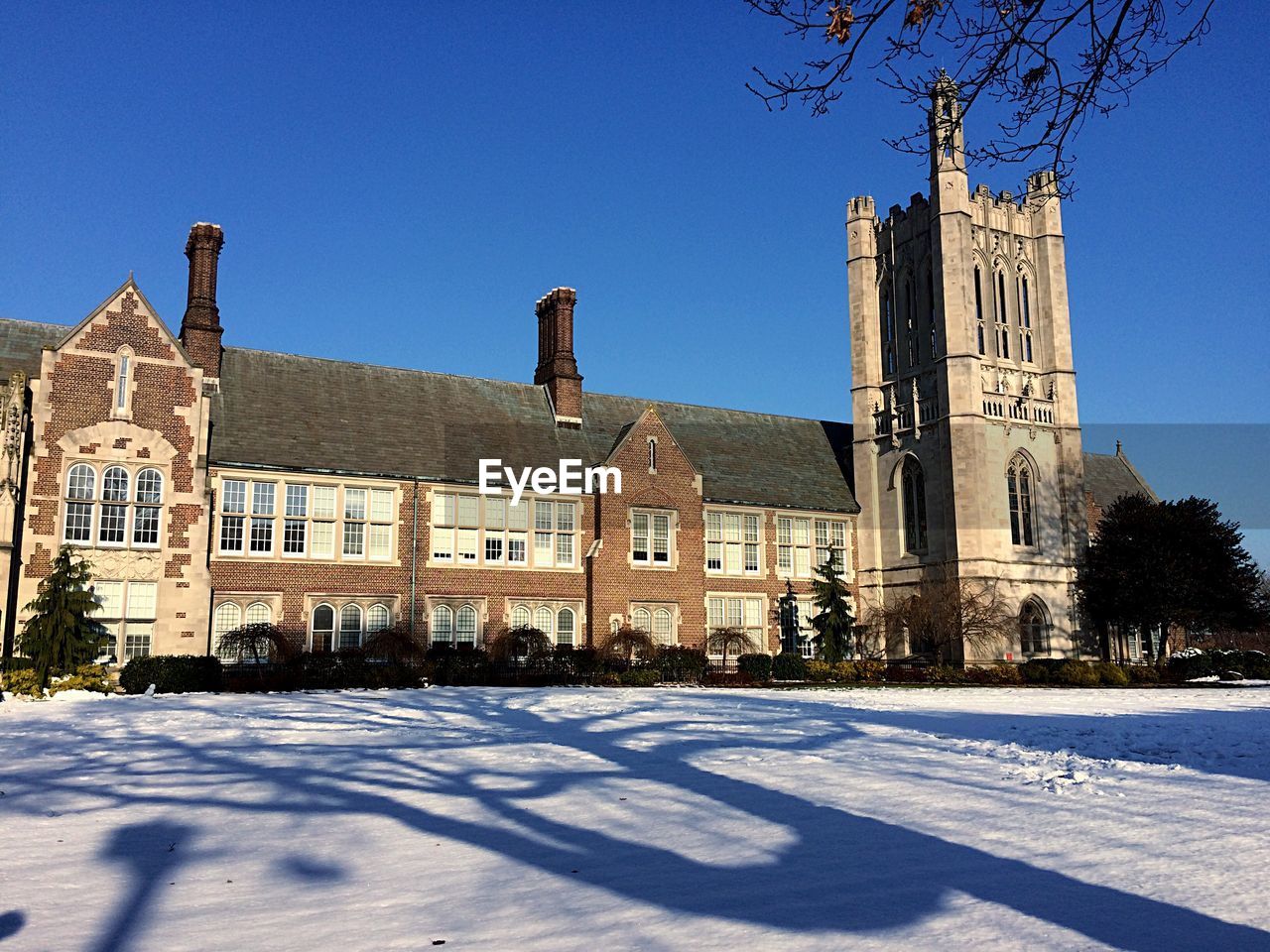 View of historic building against clear blue sky during winter