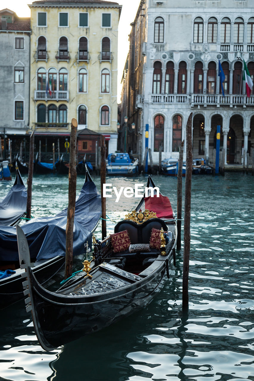 Gondolas moored on grand canal in city