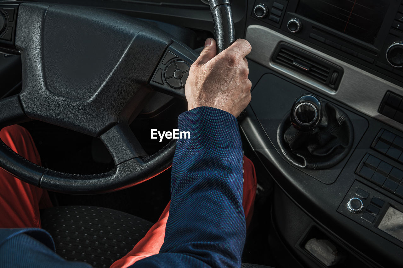 cropped hand of man using car