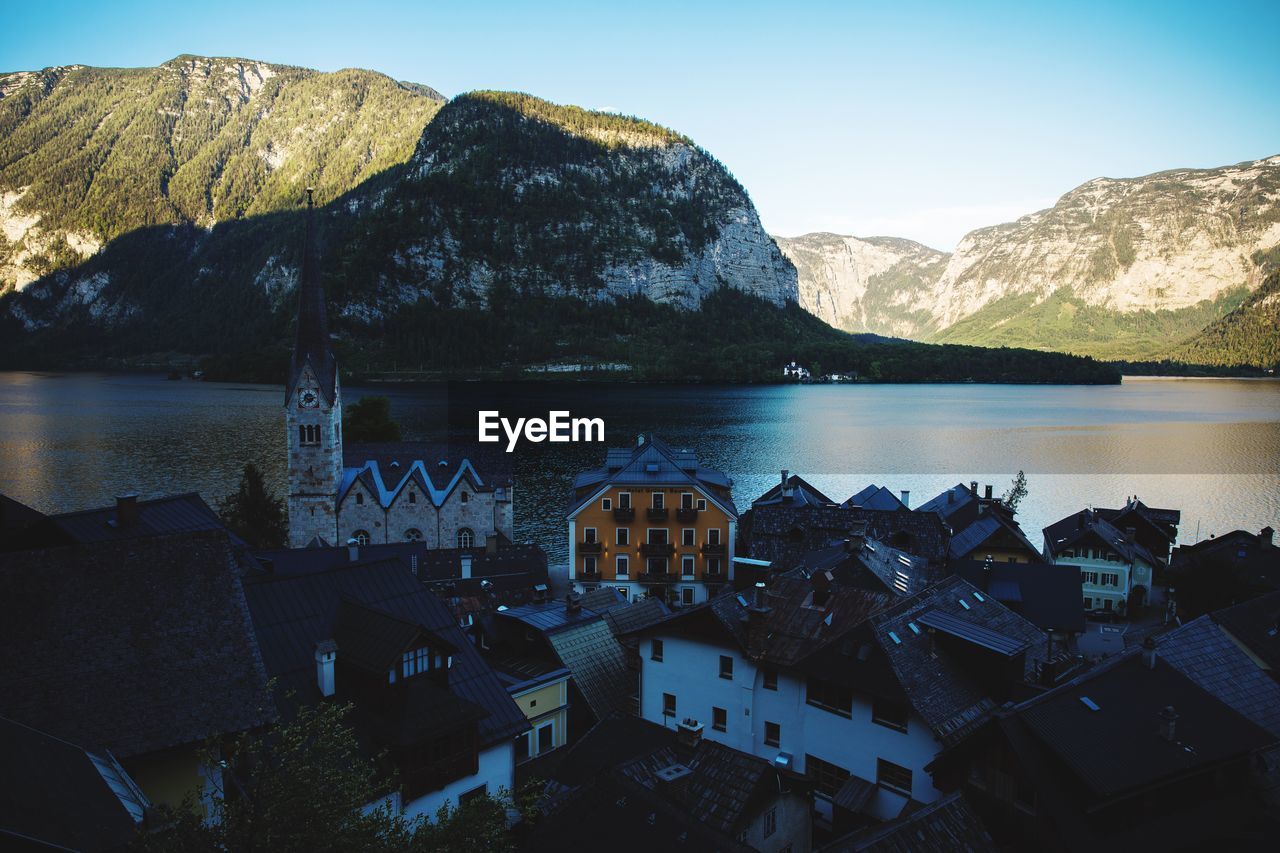 View of lake and houses against mountain range