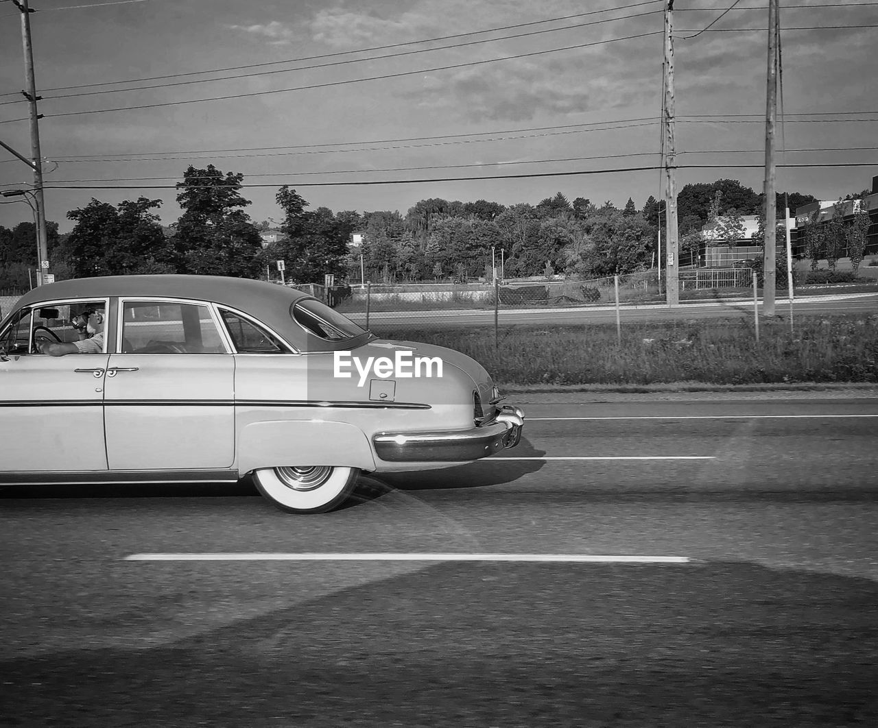 CARS ON ROAD AGAINST SKY