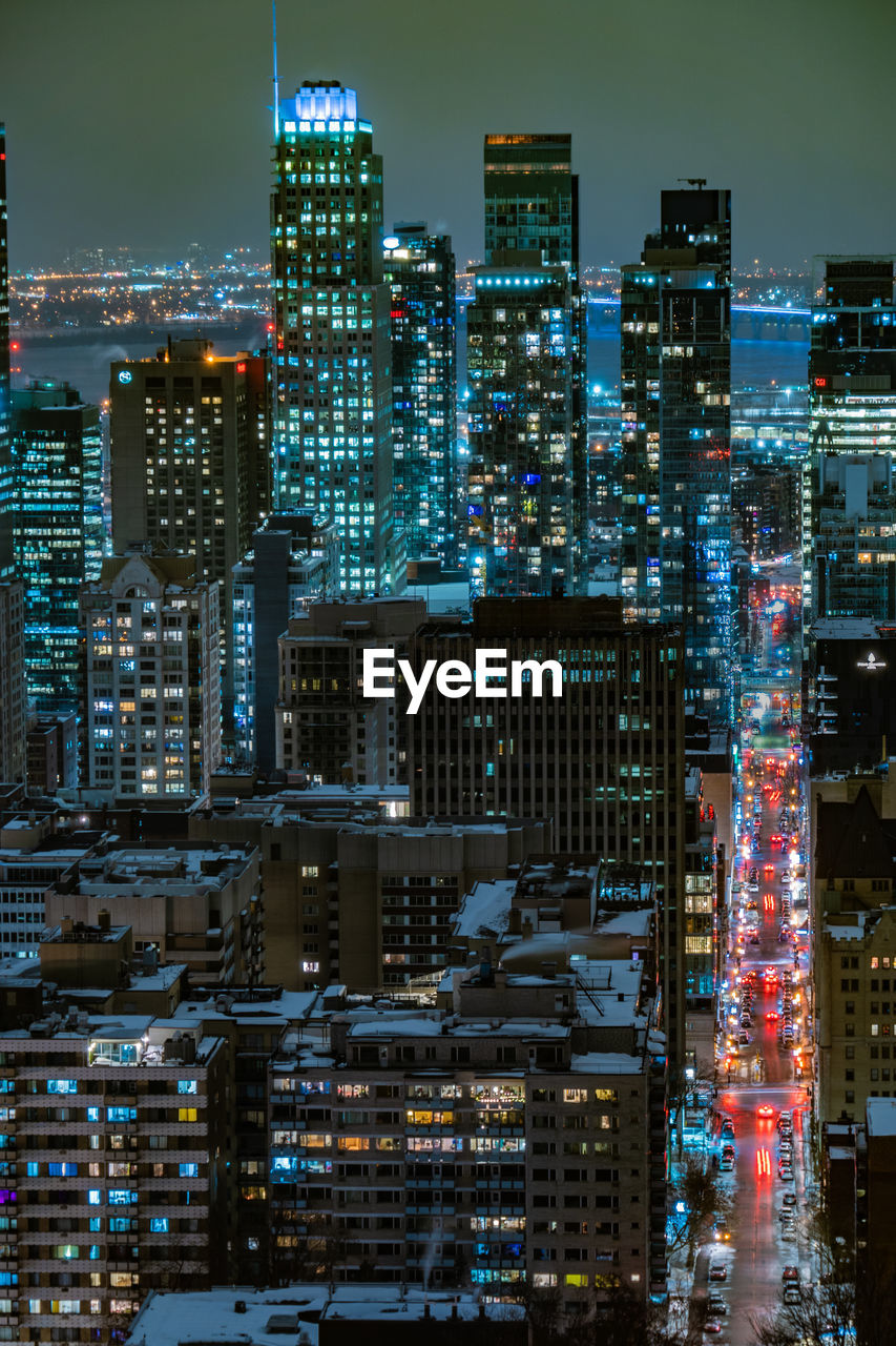illuminated cityscape against sky at night