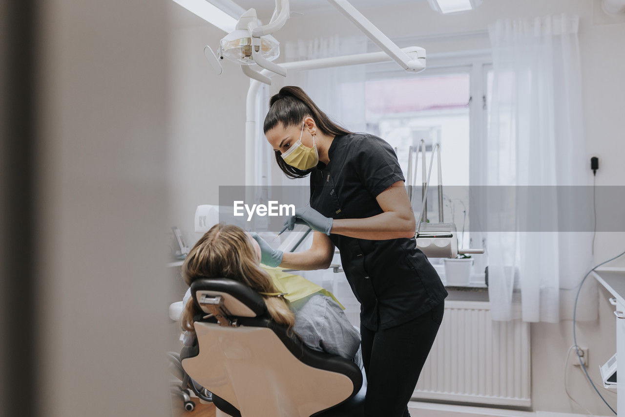 Female dentist with patient in dentist's office