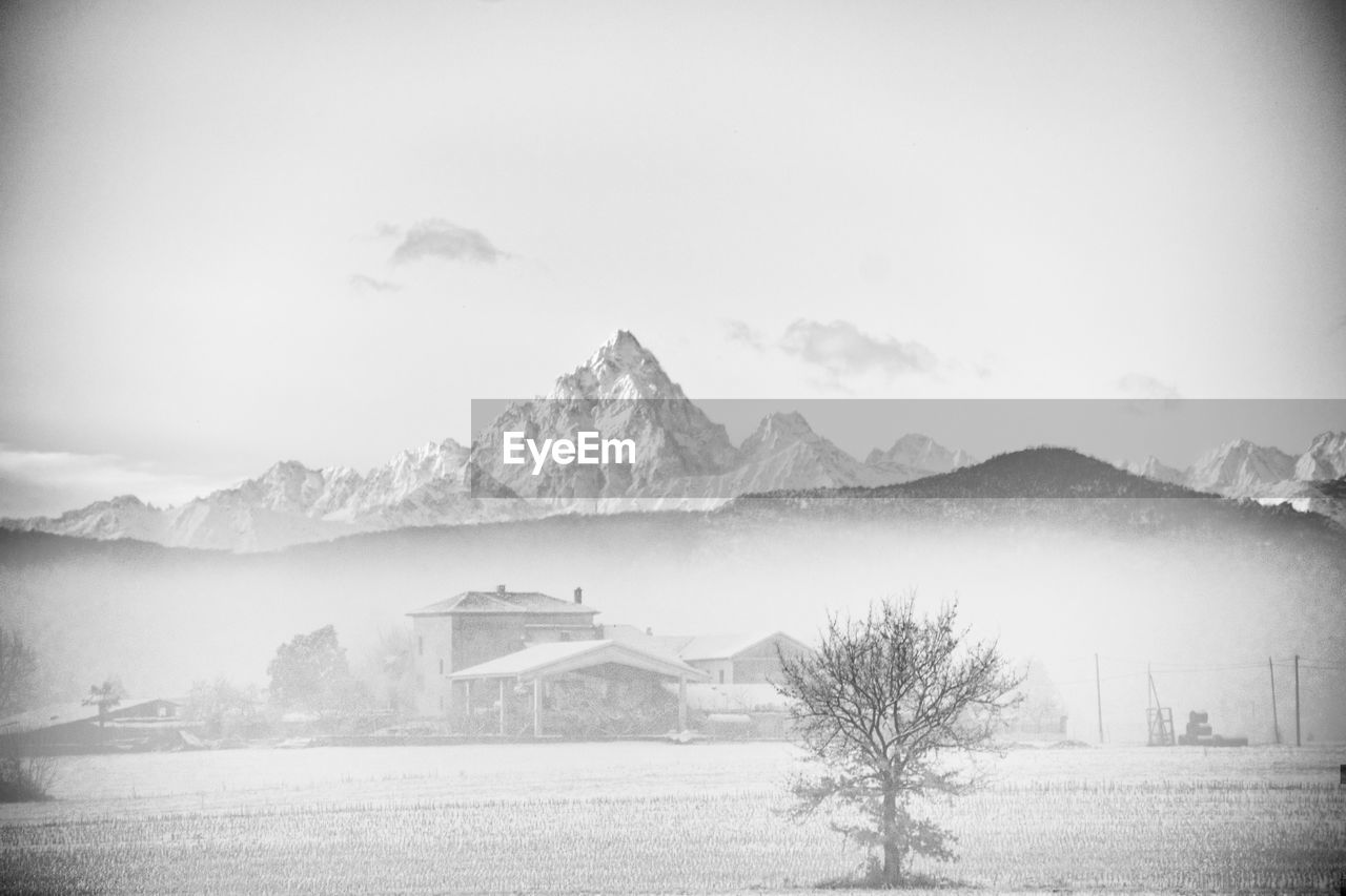 SCENIC VIEW OF LANDSCAPE AND MOUNTAINS AGAINST SKY