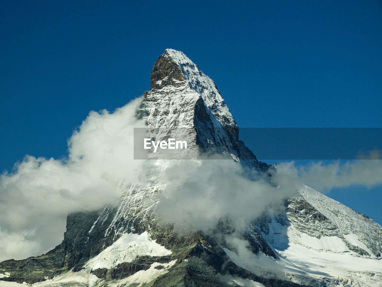 Aerial view of snowcapped mountains against sky