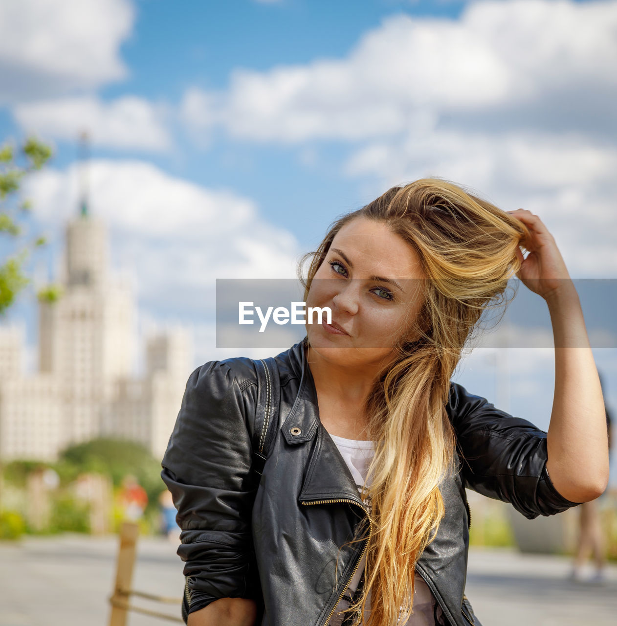 Beautiful young girl in sunglasses walks around the city person