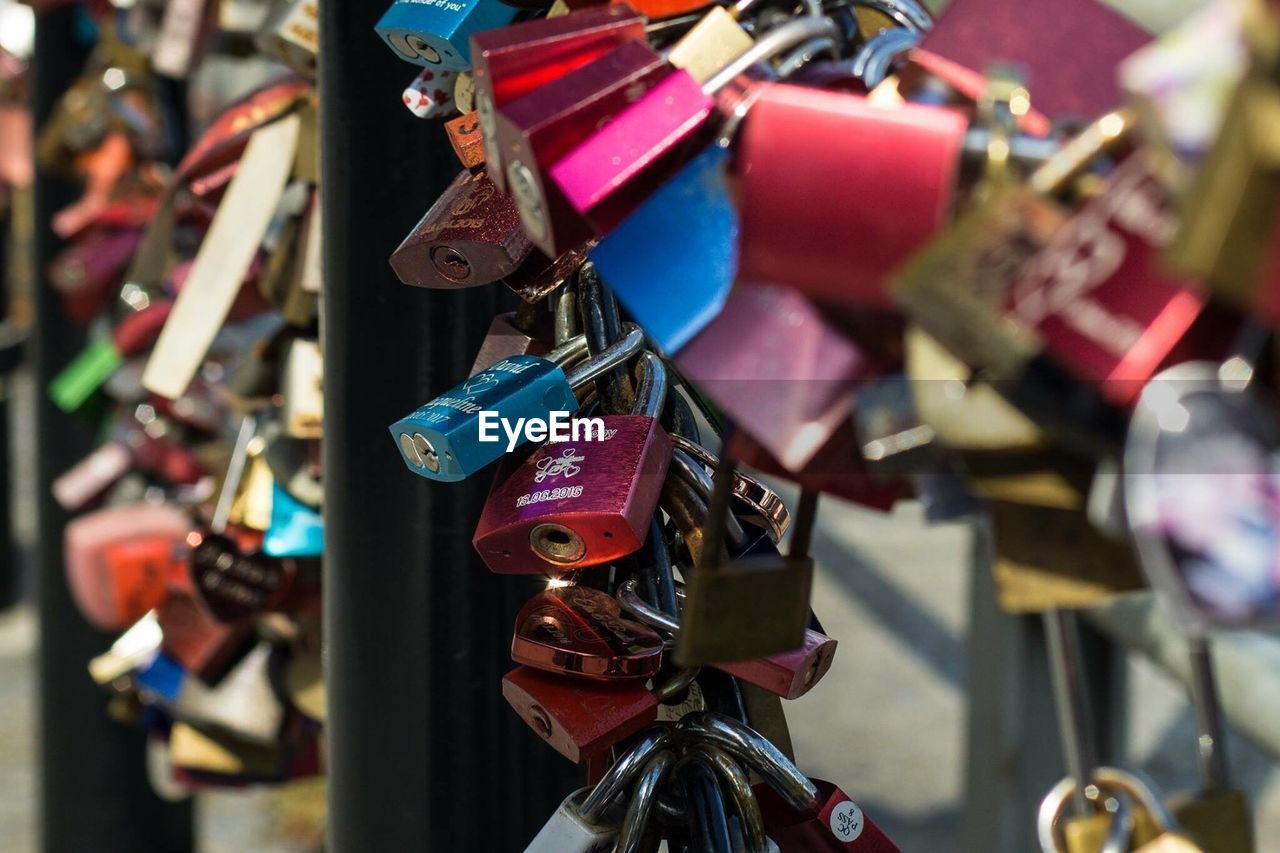 Close-up of padlocks hanging on railing