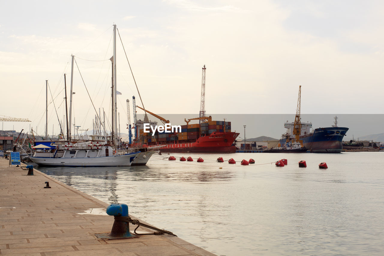 water, transportation, nautical vessel, mode of transportation, harbor, sea, pier, sky, port, commercial dock, architecture, nature, coast, industry, ship, vehicle, business, boat, sailboat, ocean, cloud, machinery, crane - construction machinery, outdoors, watercraft, occupation, dock, container, shipping, city, moored, travel, unloading, day, freight transportation, business finance and industry, infrastructure, beach, channel