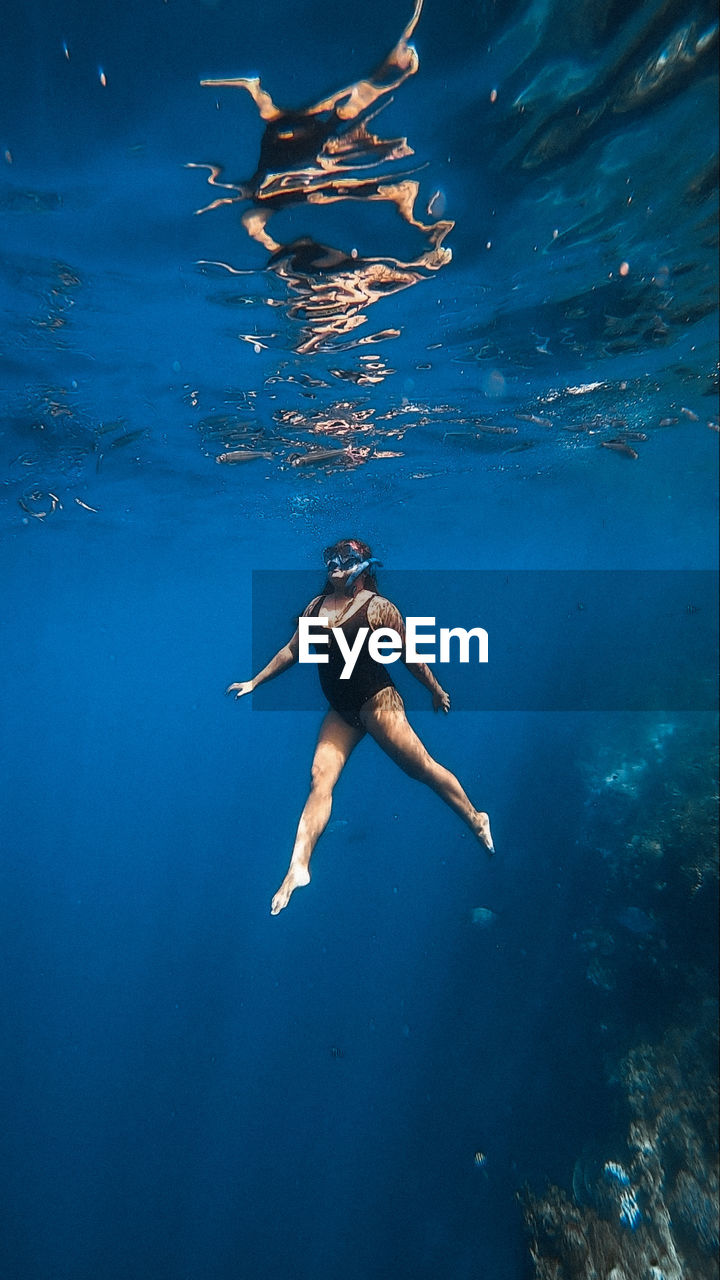 high angle view of woman swimming in sea