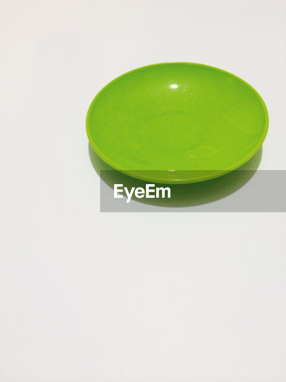Green saucer over white background