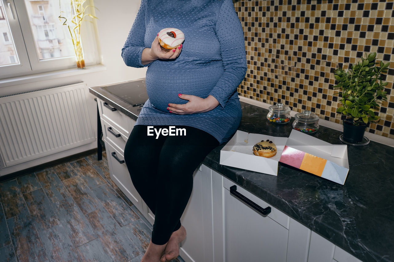 Full length of woman standing at home
