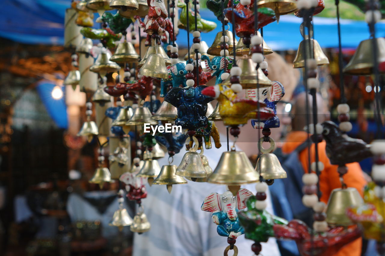 Close-up of wind chimes hanging in store for sale