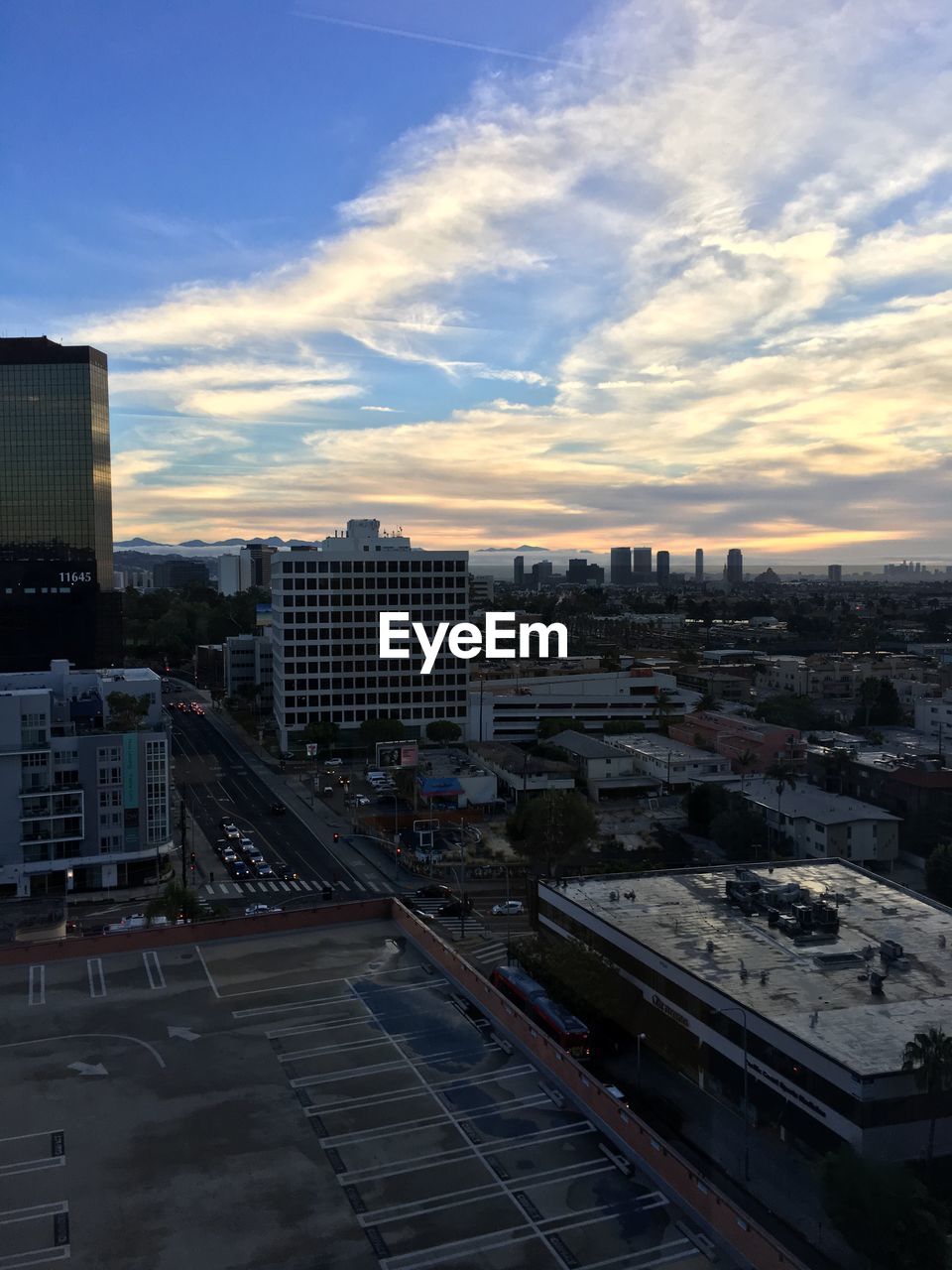 HIGH ANGLE VIEW OF CITY AGAINST SKY DURING SUNSET