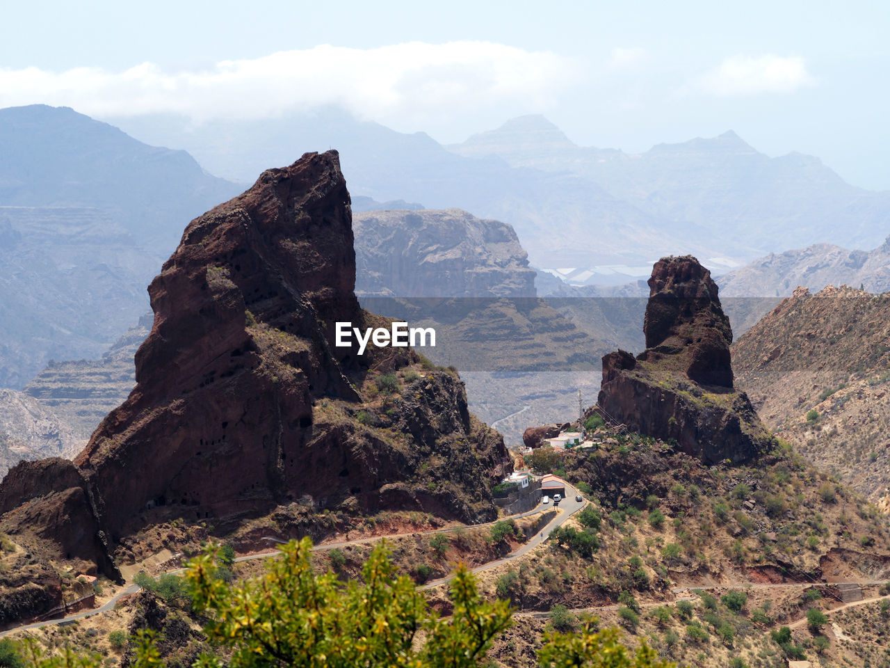 Scenic view of rock formations on landscape against sky