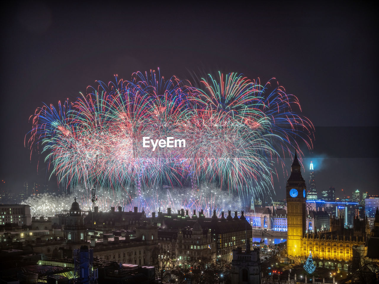 High angle view of firework display at night