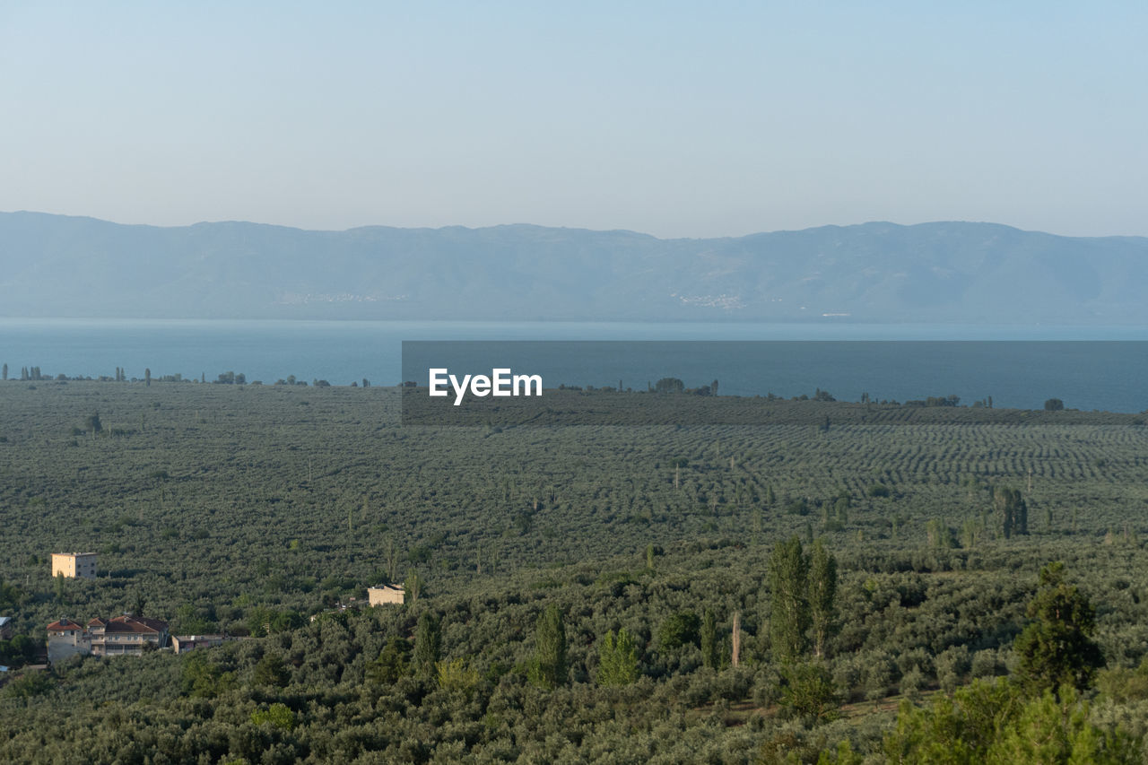 Scenic view of sea and mountains against sky