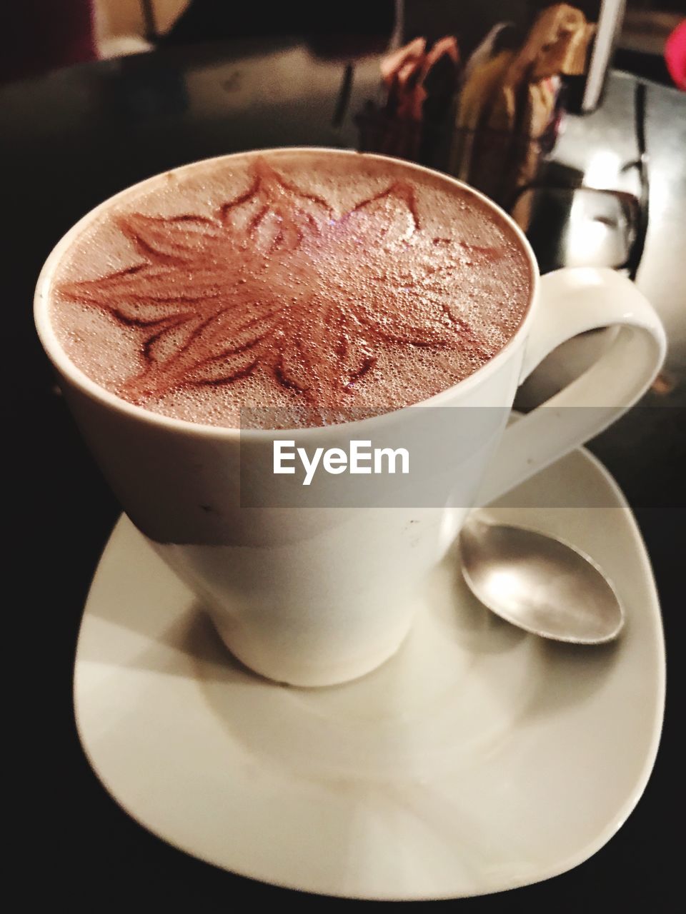 CLOSE-UP OF COFFEE IN GLASS ON TABLE