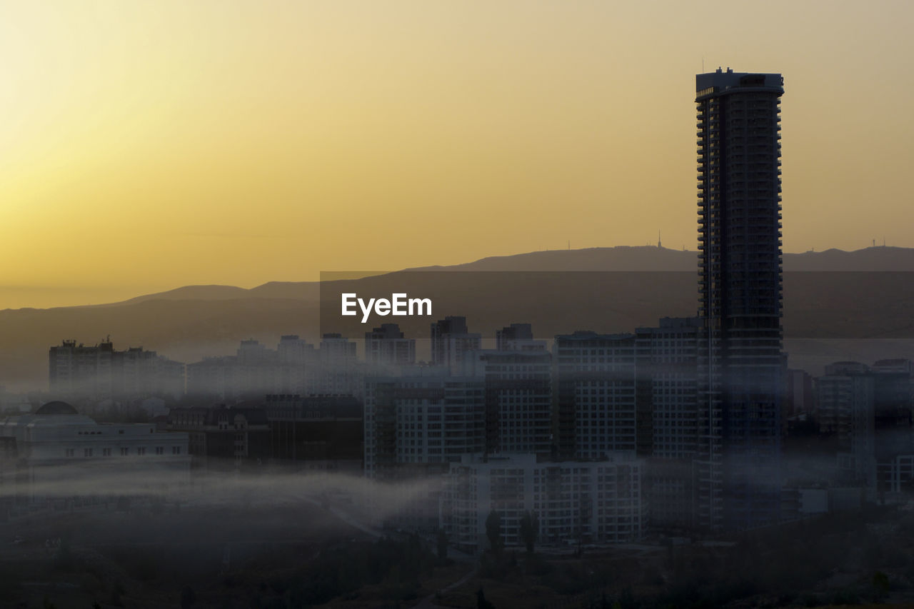 The city is in a fog at sunrise