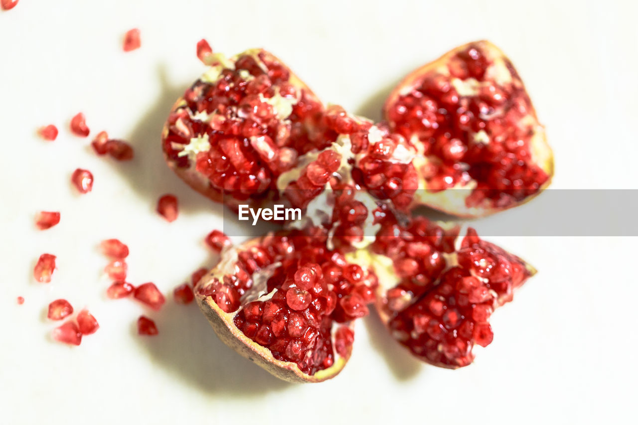 pomegranate, food and drink, food, fruit, healthy eating, red, plant, seed, wellbeing, freshness, pomegranate seed, produce, berry, studio shot, antioxidant, no people, indoors, ripe, dried food, cut out, close-up, vitamin, dried fruit, high angle view, cranberry, sweet food, juicy