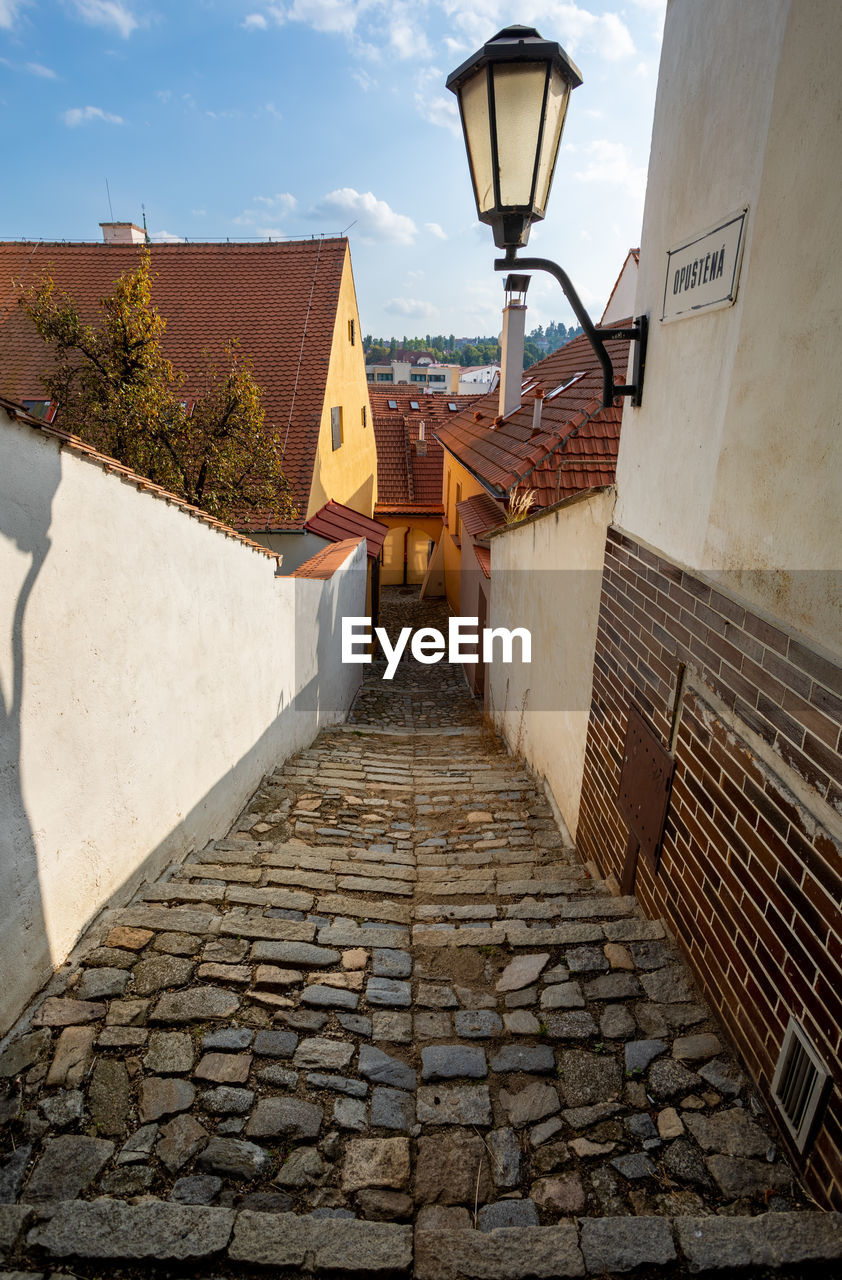 STREET LIGHT BY WALL OF BUILDING