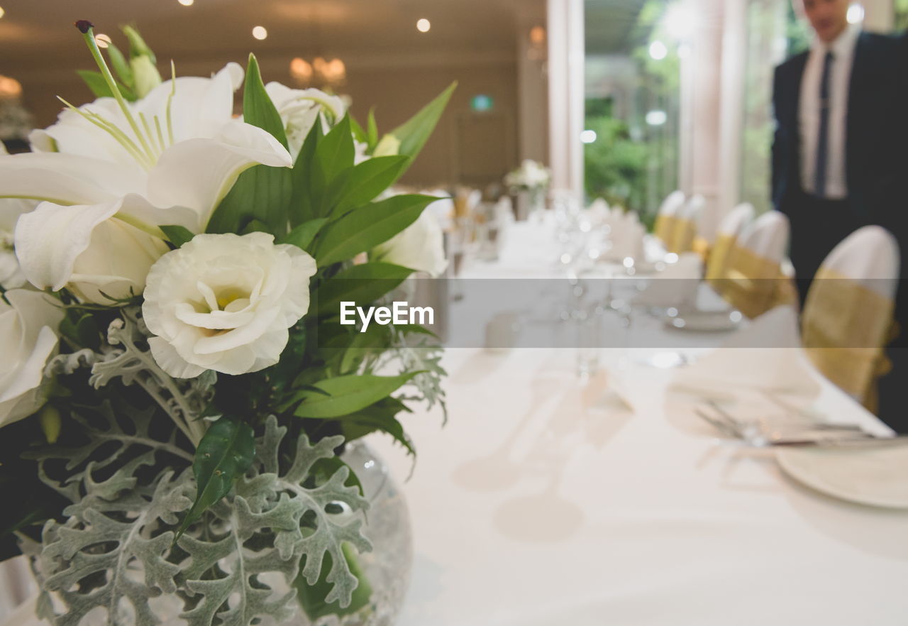 White flowers in vase on table