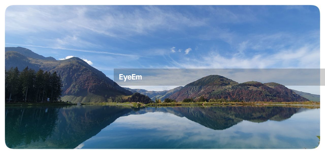 Scenic view of lake and mountains against sky