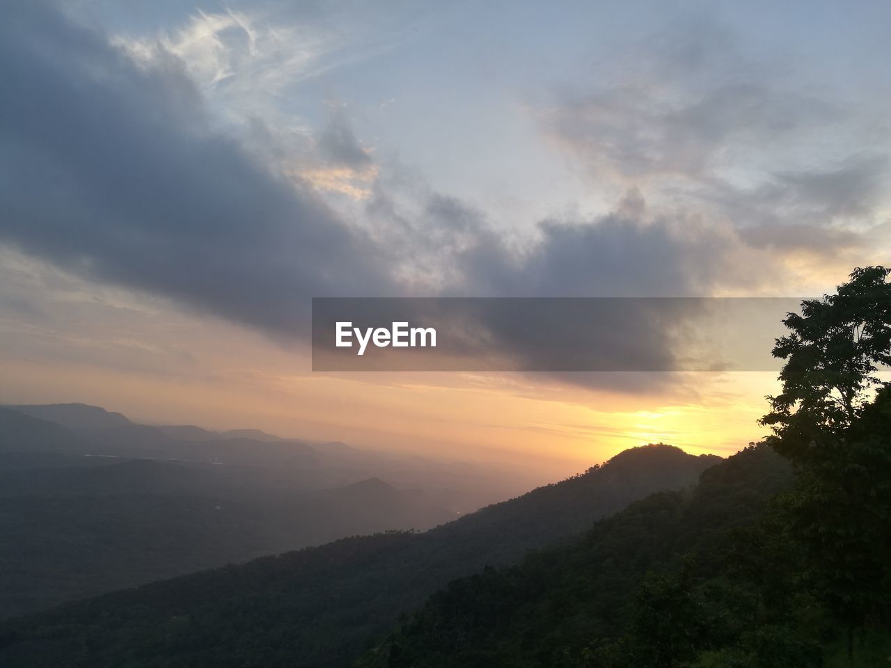 Scenic view of silhouette mountains against sky at sunset