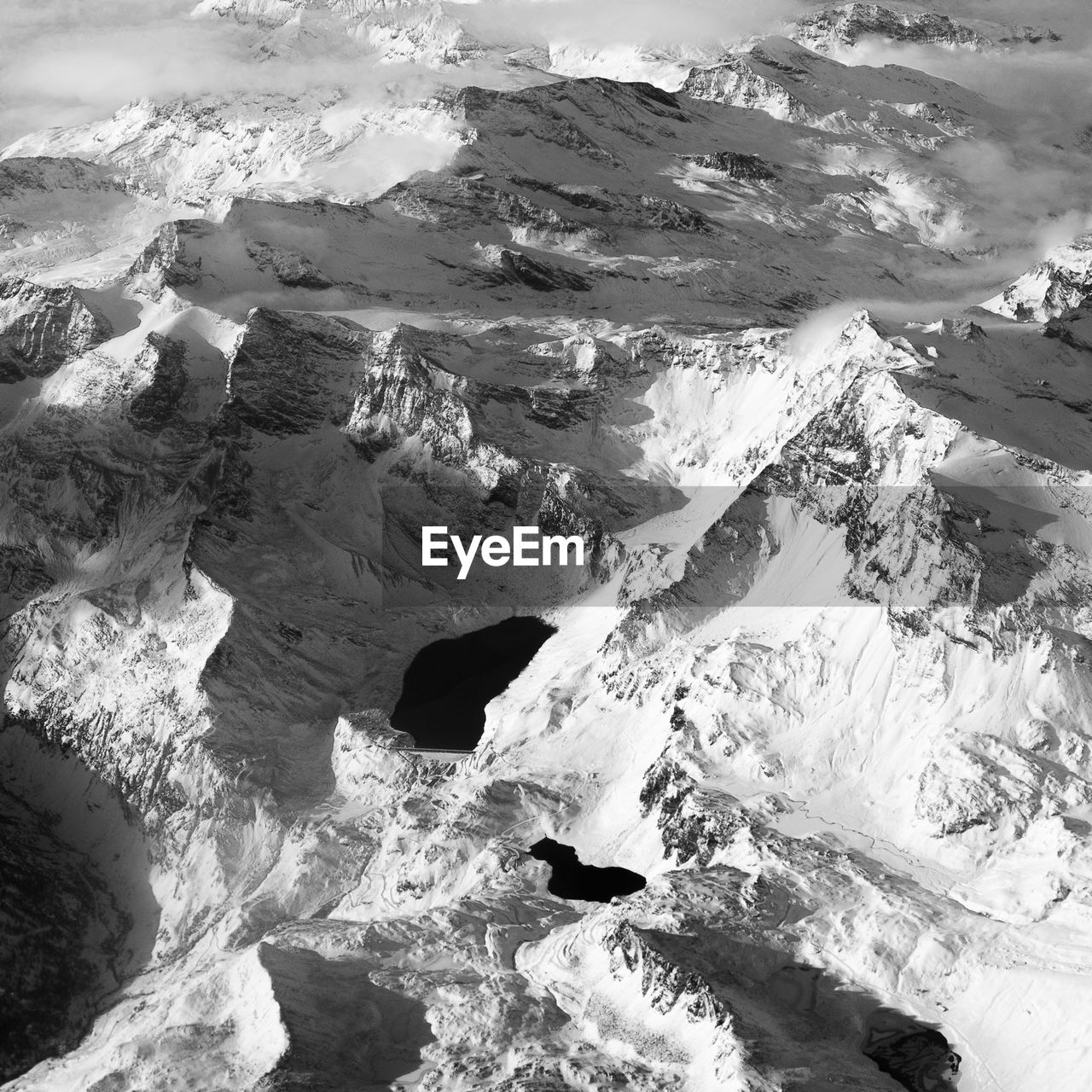 AERIAL VIEW OF SNOW COVERED LANDSCAPE