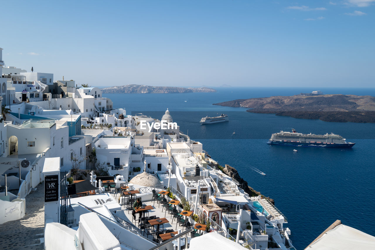 high angle view of city by sea against sky