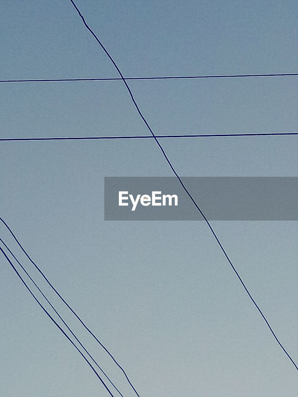 LOW ANGLE VIEW OF TELEPHONE POLE AGAINST SKY
