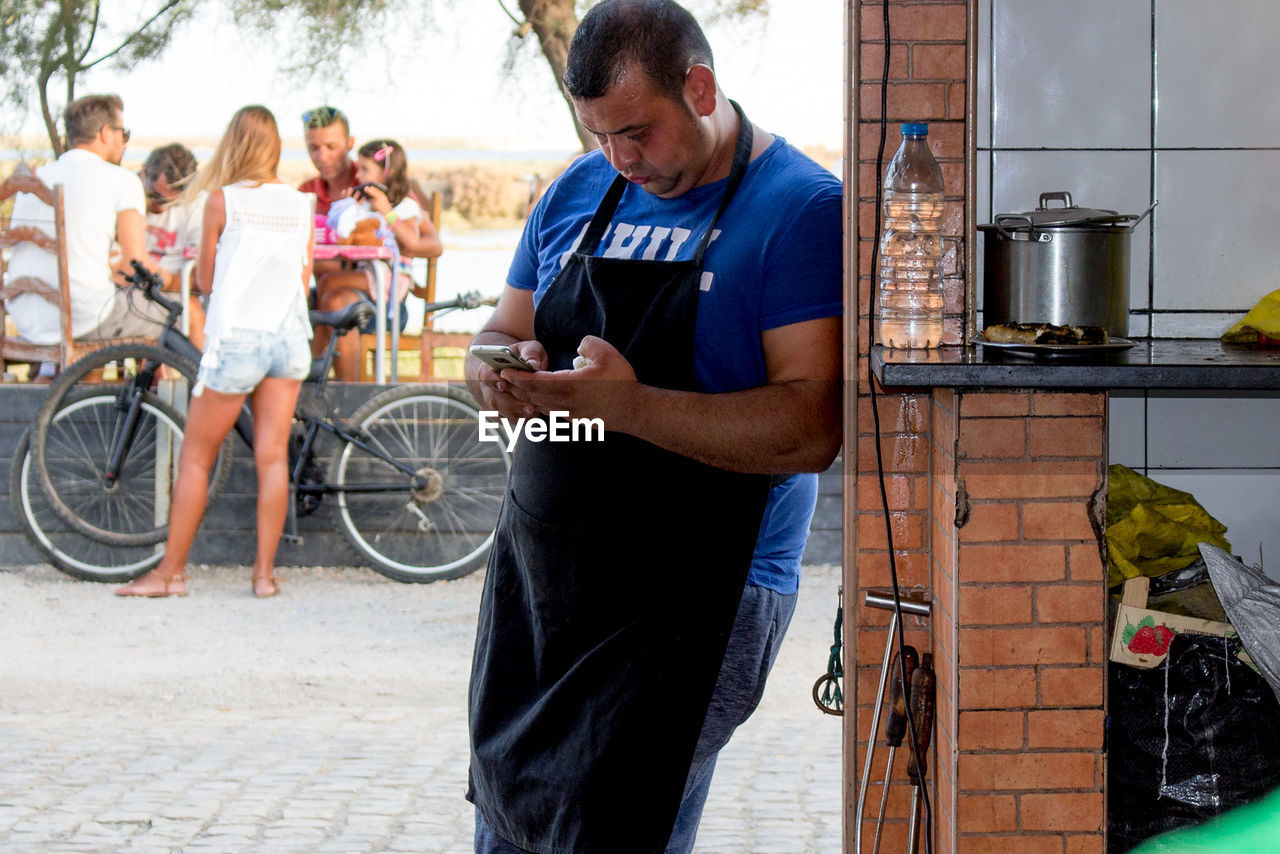 PEOPLE LOOKING AT BICYCLES