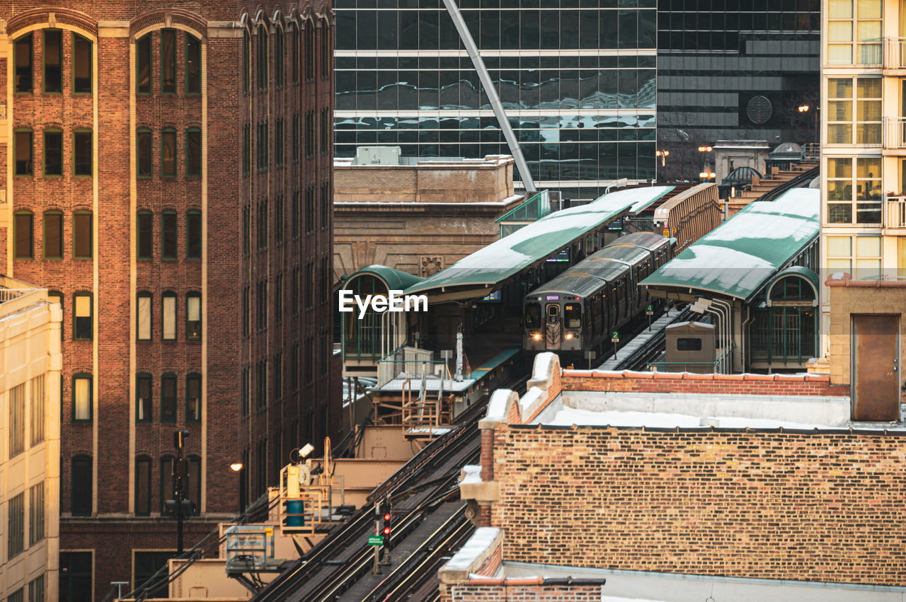 Railroad tracks amidst buildings in city