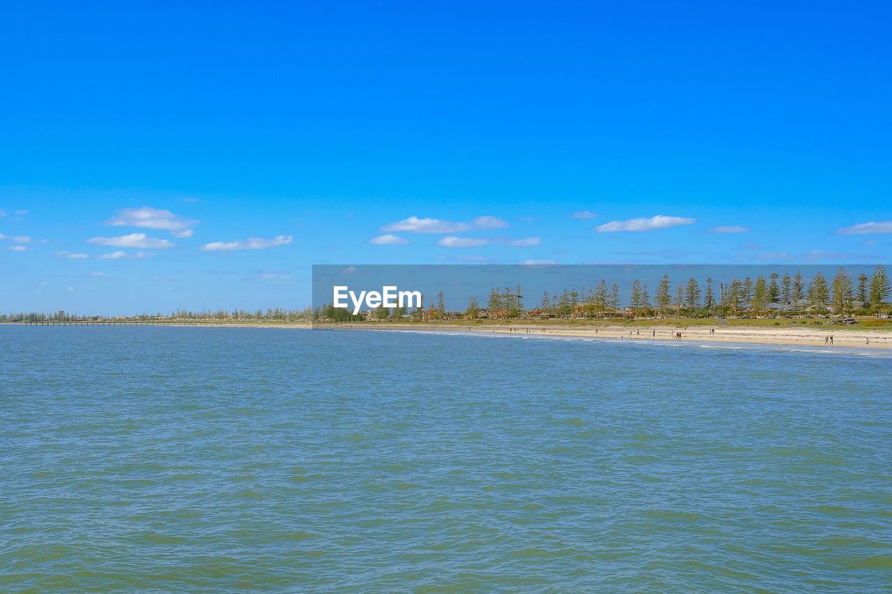 Scenic view of lake against clear blue sky