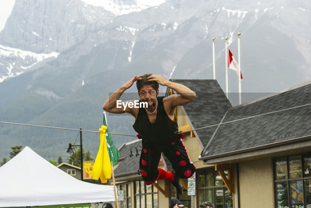 WOMAN STANDING ON MOUNTAIN