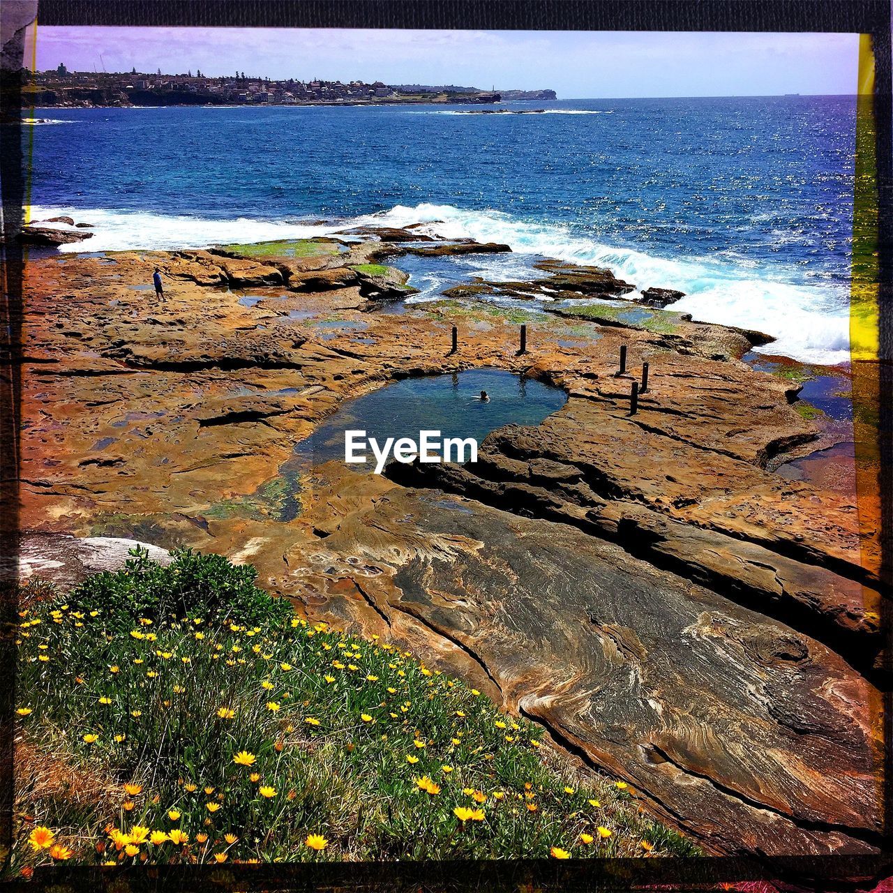 SCENIC VIEW OF SEA WITH ROCKS IN BACKGROUND