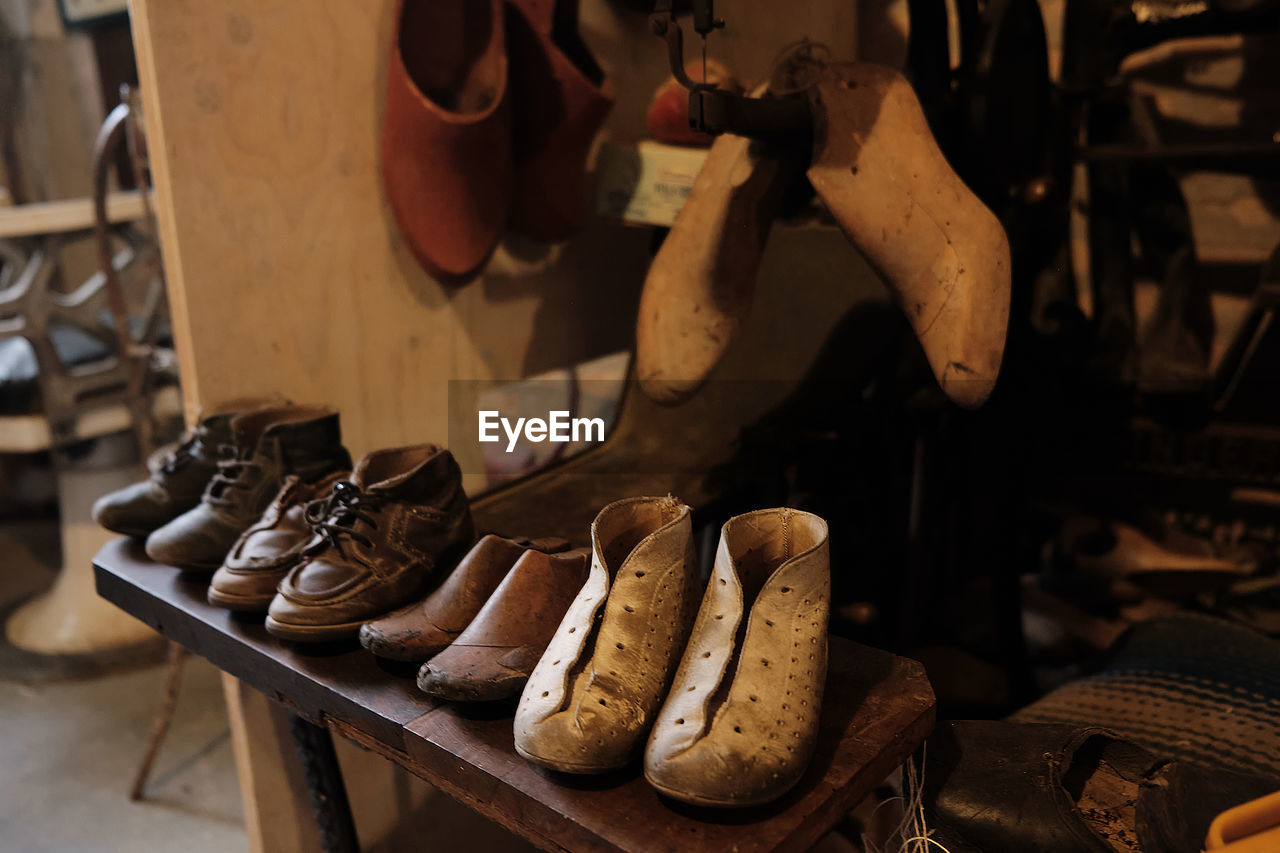 Old workshop of a cobbler shoemaker with old shoes and patterns and work tools