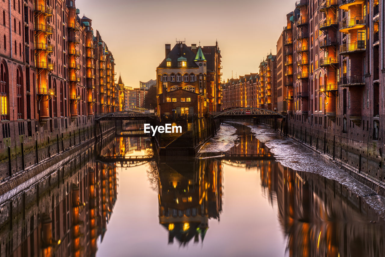 REFLECTION OF BUILDINGS IN RIVER