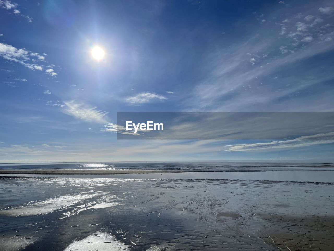 sky, water, horizon, sunlight, scenics - nature, cloud, sea, nature, reflection, ocean, beauty in nature, wave, land, environment, wind wave, tranquility, beach, landscape, blue, sun, horizon over water, dawn, shore, tranquil scene, no people, morning, outdoors, cold temperature, body of water, sunrise, light, coast, ice, sunbeam, winter, travel, travel destinations, snow