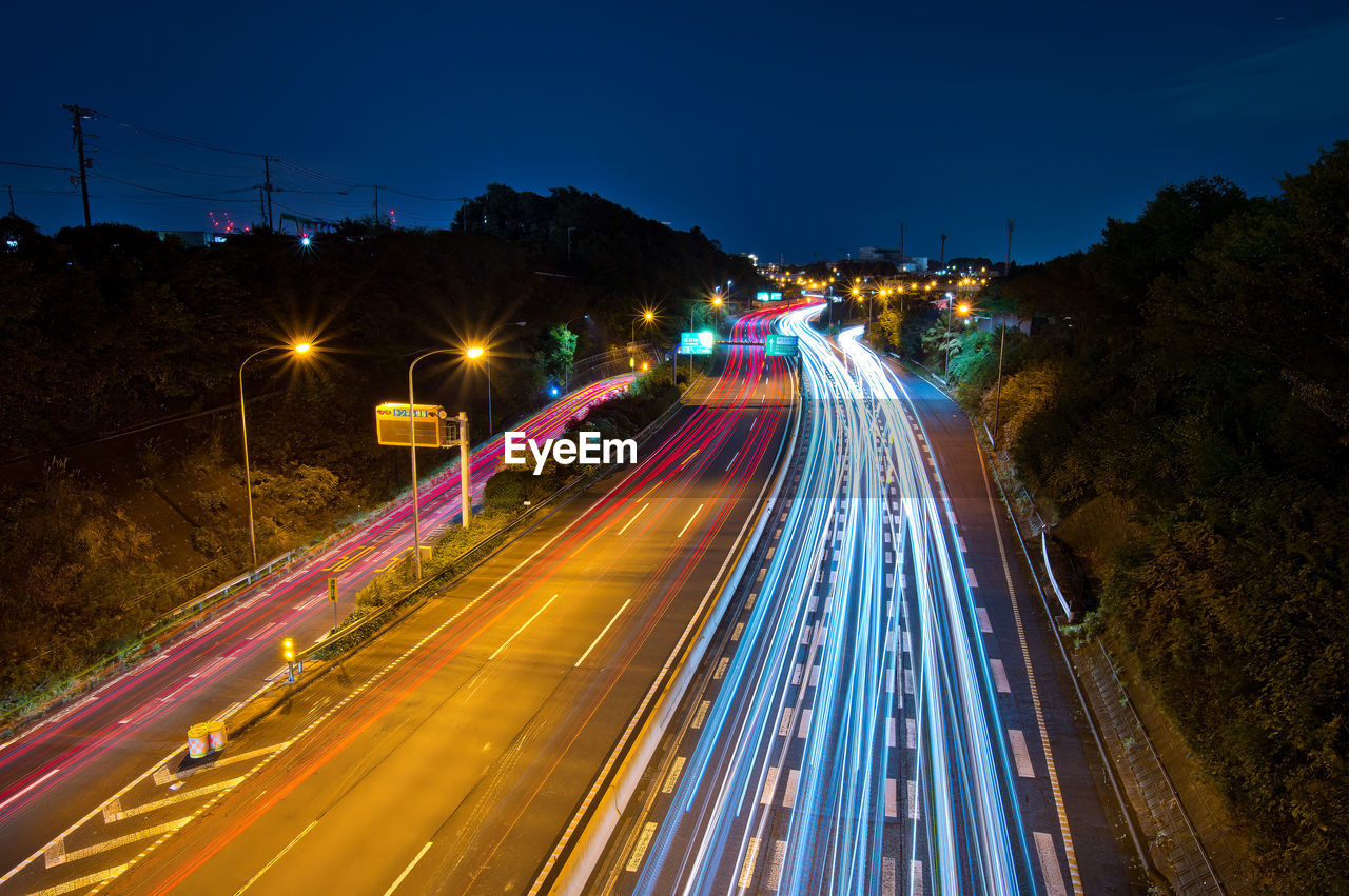 High angle view of light trails on road at night