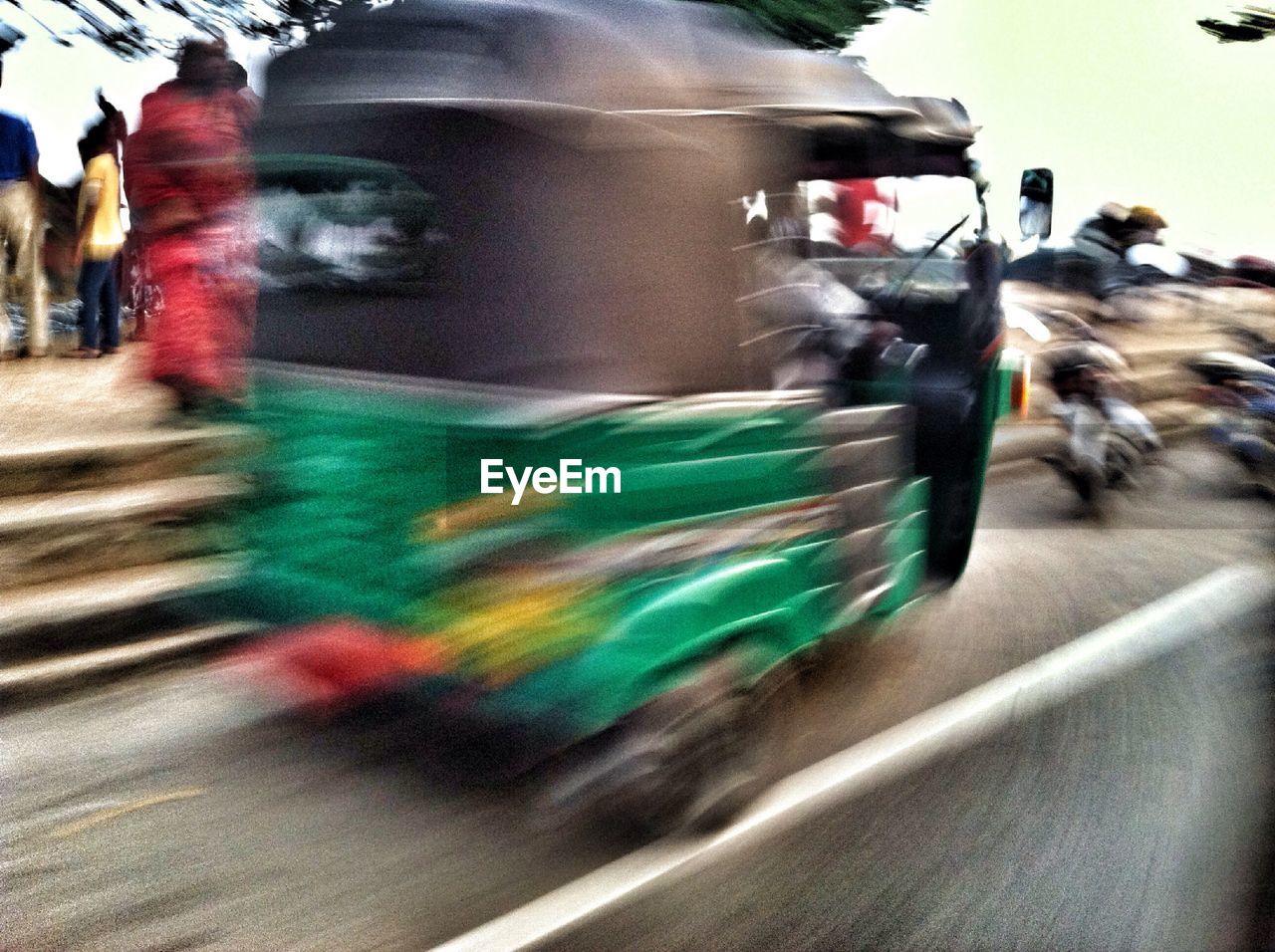 Defocused image of moving rickshaw on street