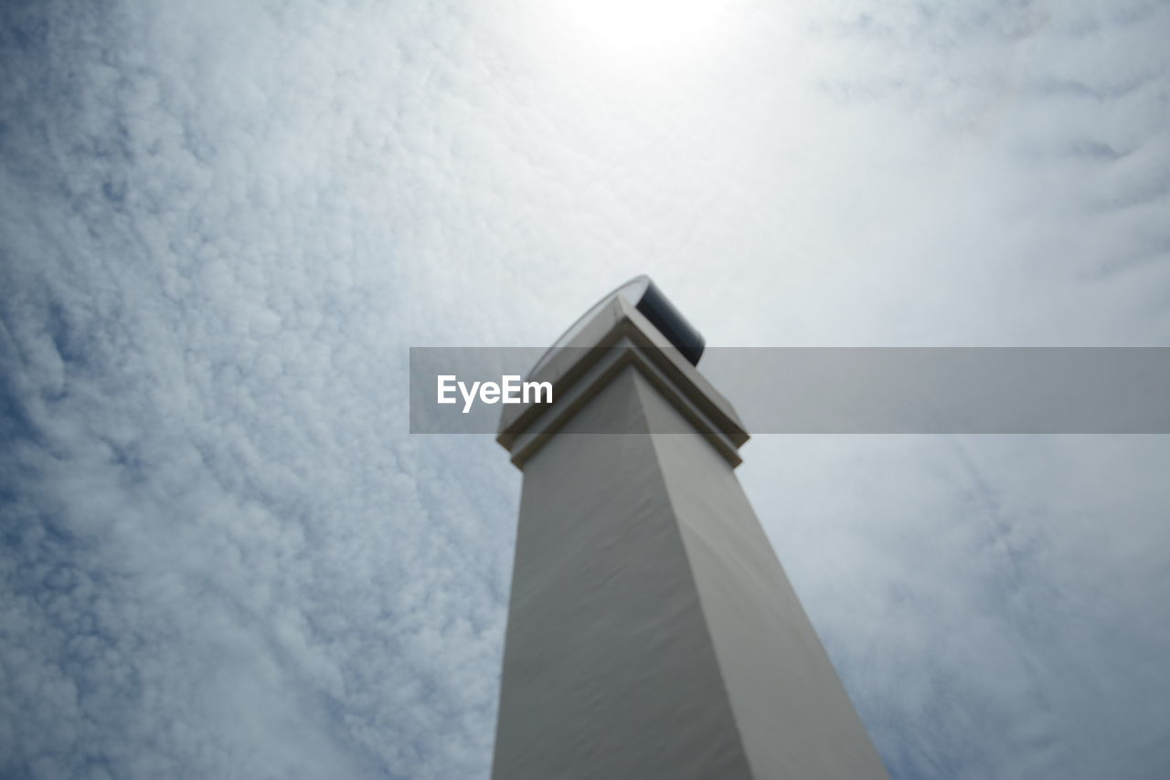Low angle view of architectural column against cloudy sky