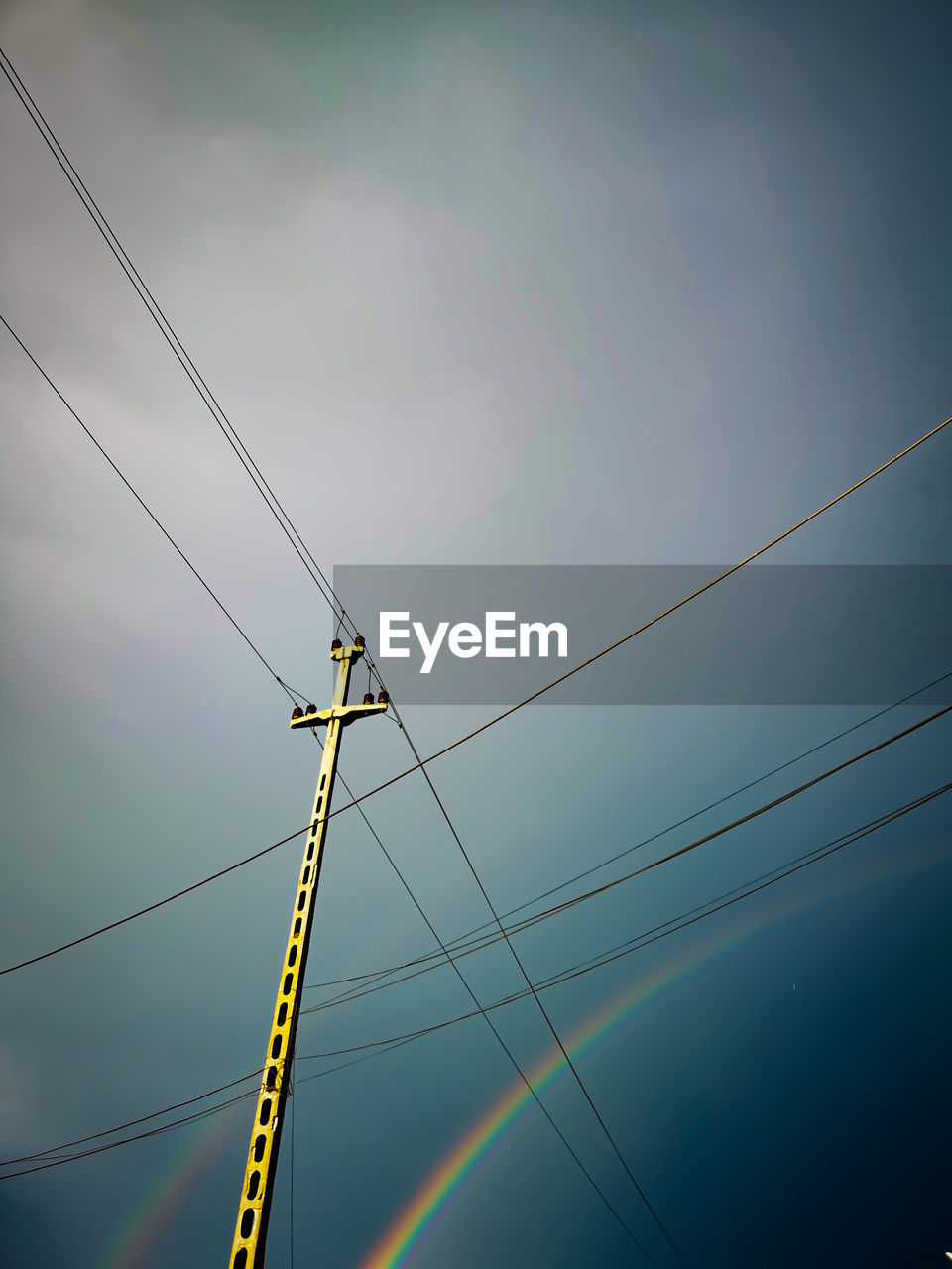 Low angle view of power lines against sky