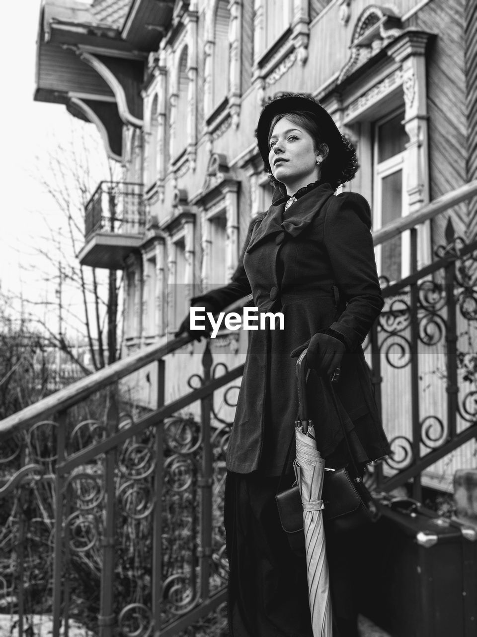 Woman standing on steps against building