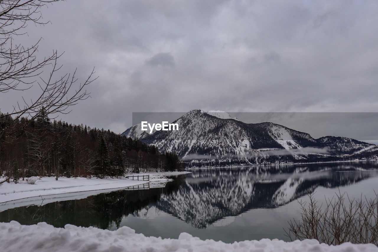 Scenic view of lake and snowcapped mountains against sky