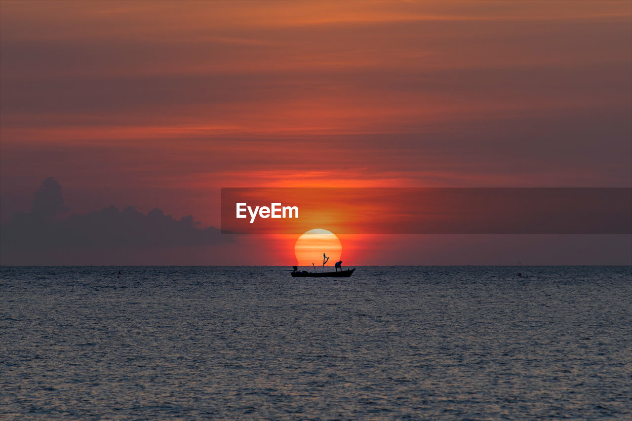 Scenic view of sea against orange sky