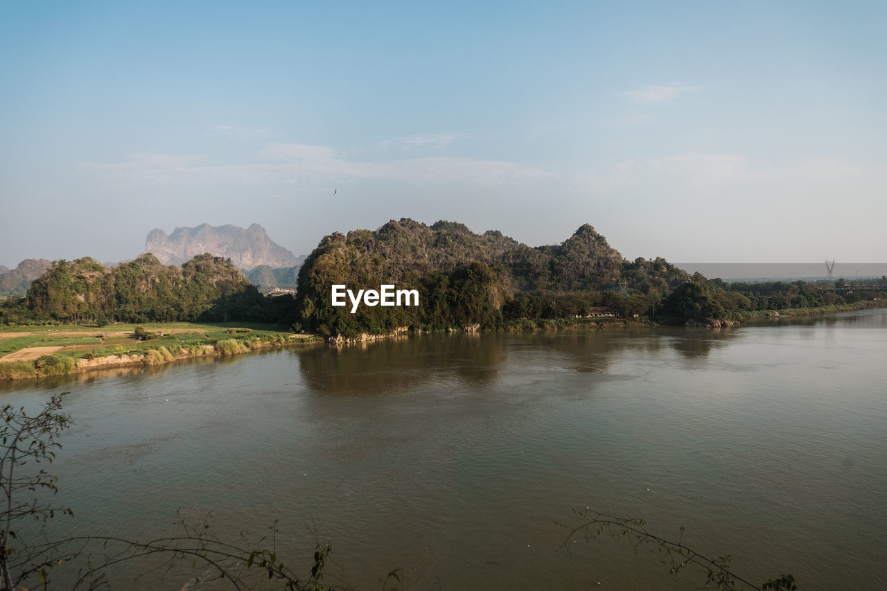 Scenic view of river and mountains against sky in hpa-an