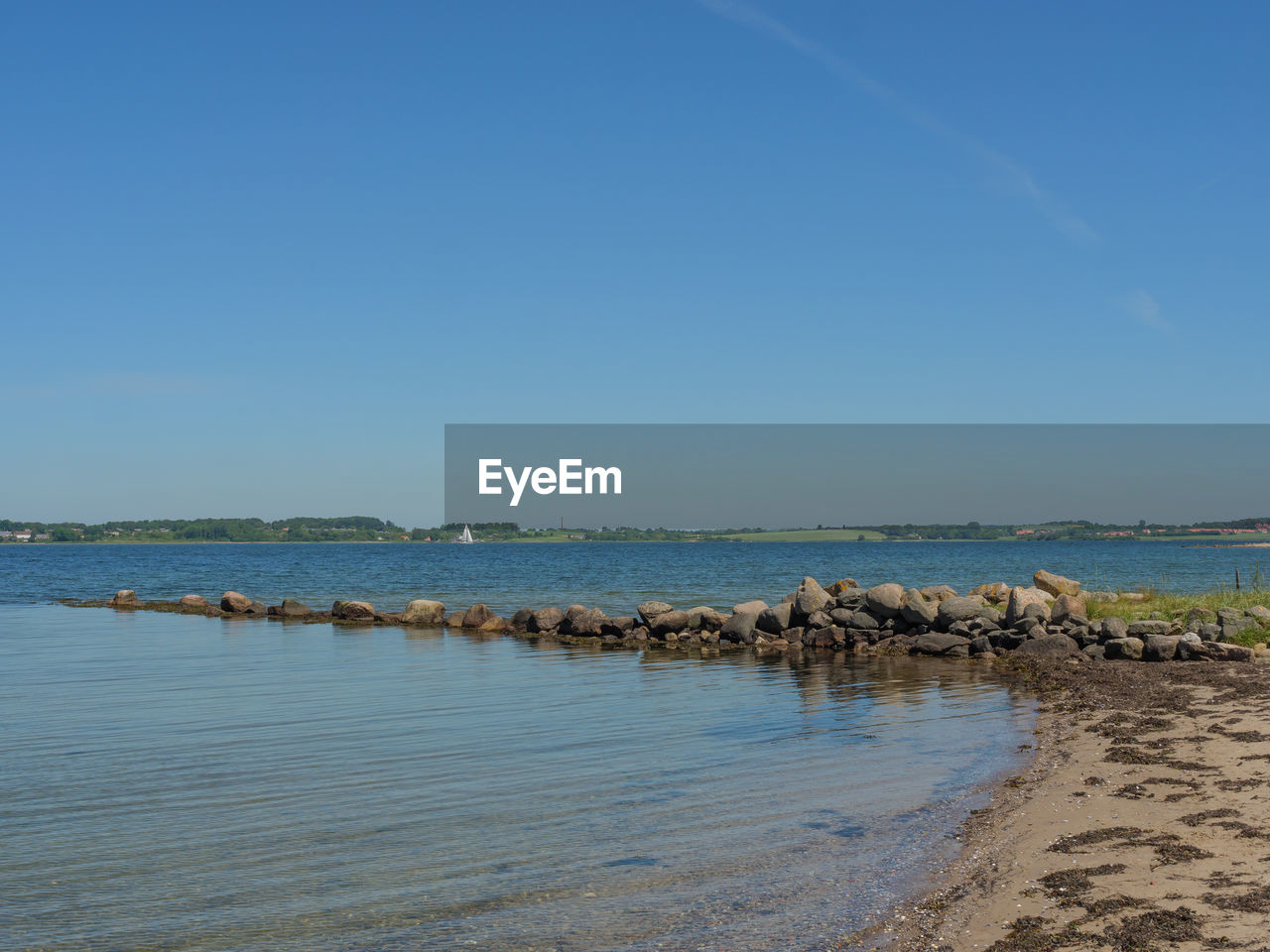 SCENIC VIEW OF BEACH AGAINST CLEAR SKY