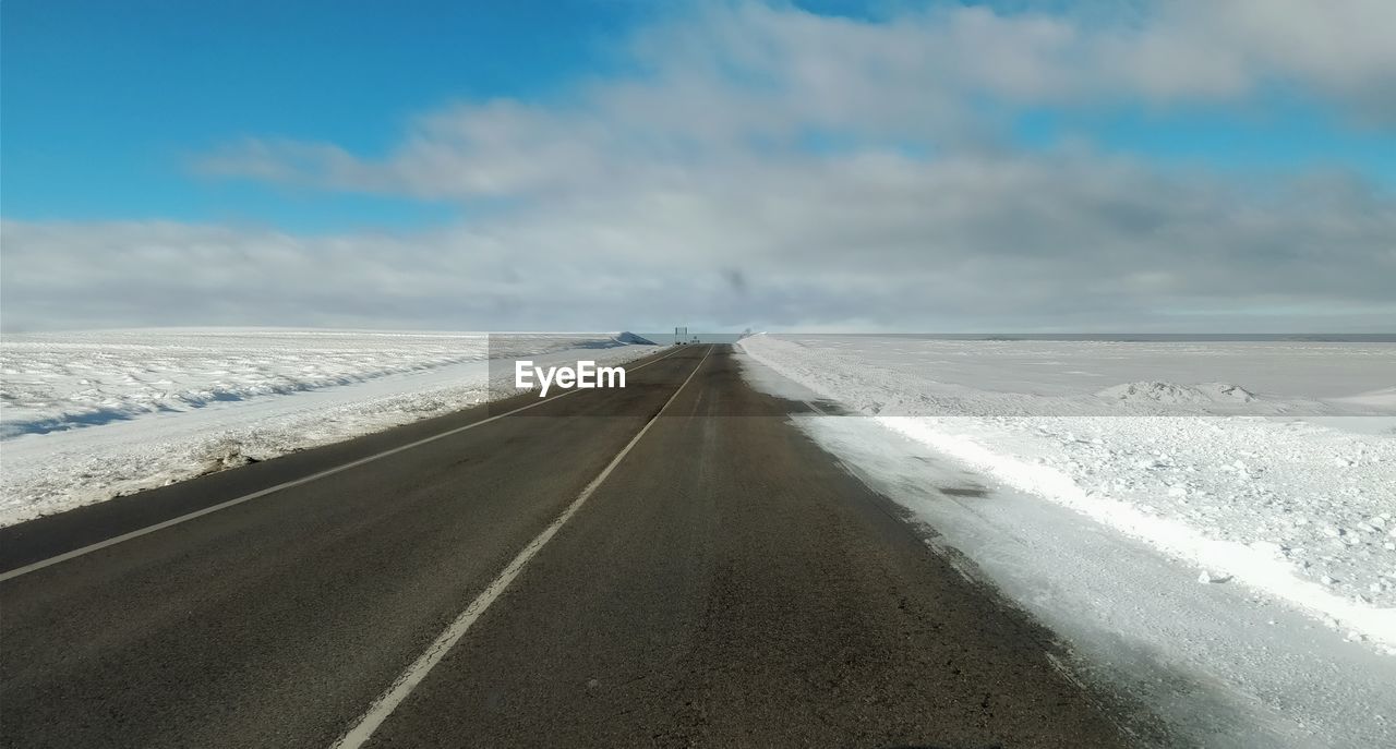 ROAD ON SNOW COVERED LANDSCAPE
