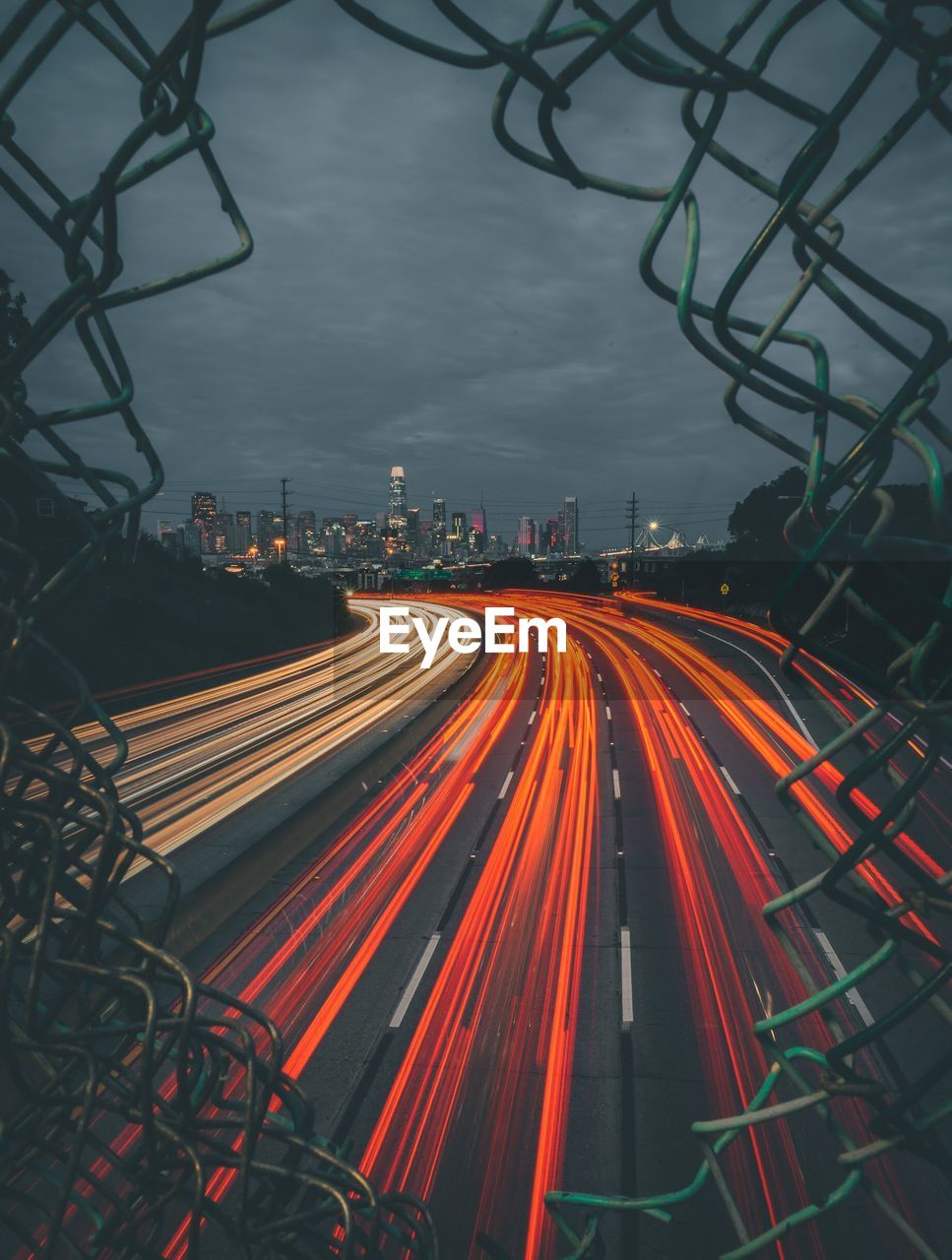 High angle view of light trails on street amidst buildings in city