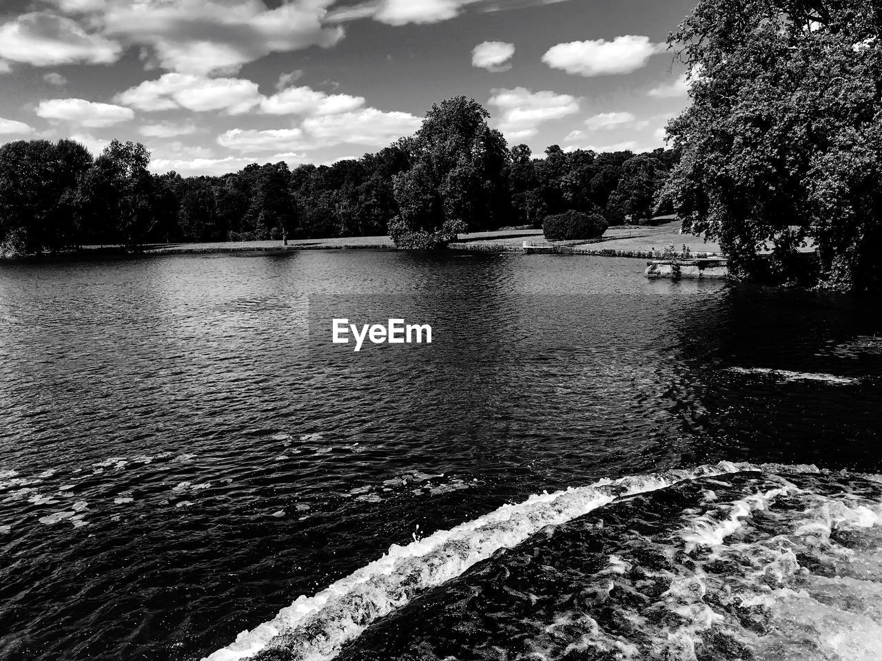 RIVER AMIDST TREES AGAINST SKY